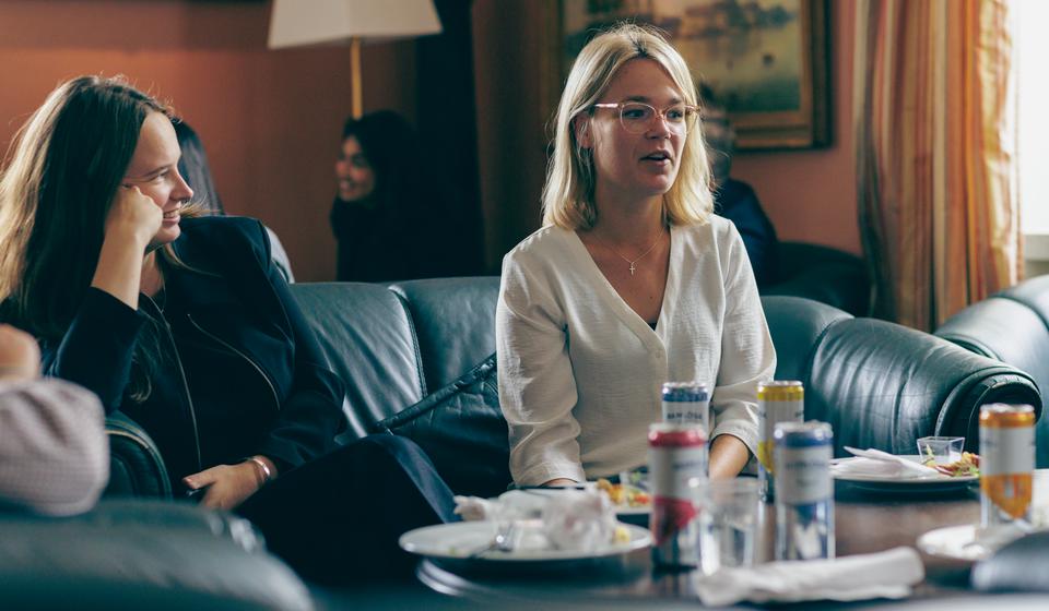 Two female students on a couch in the Mess.