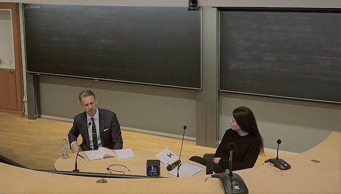 Karl Sörenson at a desk in a lecture hall. 