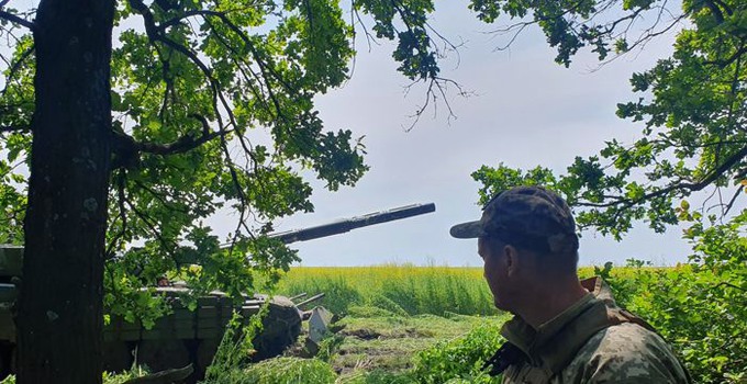 A soldier looking over a field.