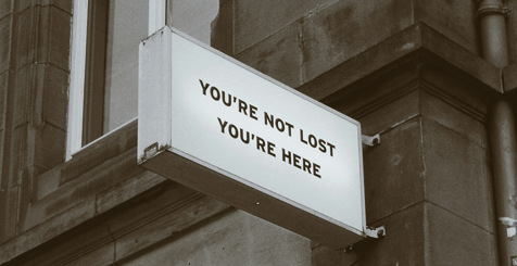 Sign on the wall that says, you are not lost you are here