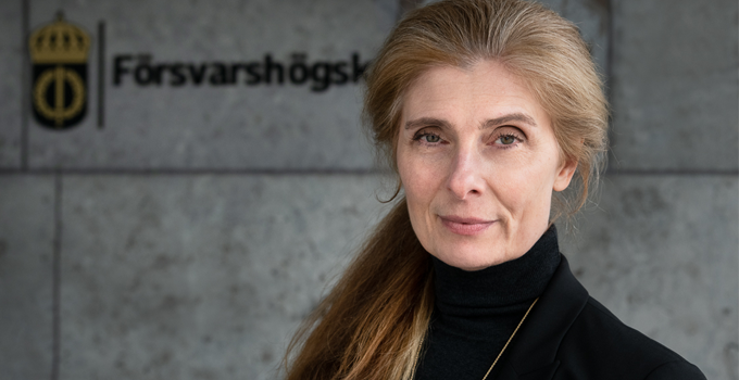 Person standing outside main entrance to the Swedish Defence University 