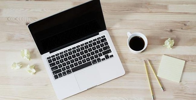 Laptop and coffe on a table.