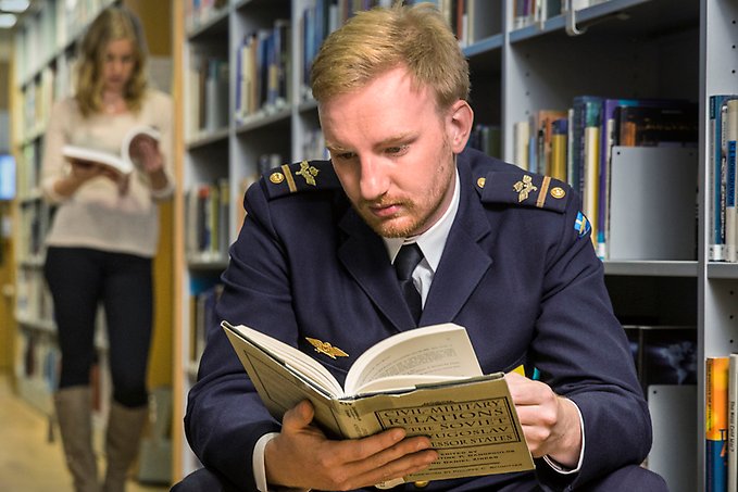 Student som läser bok på Anna Lind-biblioteket