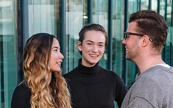 Three students talking to each other